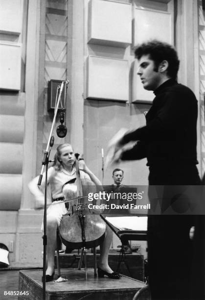 Photo of Jacqueline DU PRE and Daniel BARENBOIM, Jacqueline Du Pre performing in recording studio with Daniel Barenboim conducting