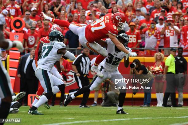 Tight end Travis Kelce of the Kansas City Chiefs leaps into the end zone over Malcolm Jenkins and Rasul Douglas of the Philadelphia Eagles in the...