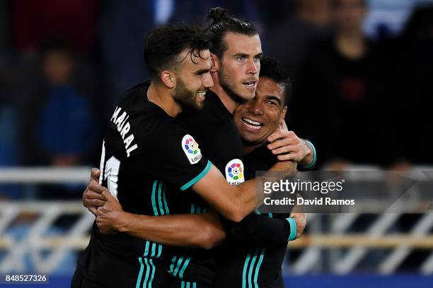 Gareth Bale of Real Madrid CF celebrates with his team mates Borja Mayoral and Carlos Enrique Casimiro after scoring his team's third goal during the...