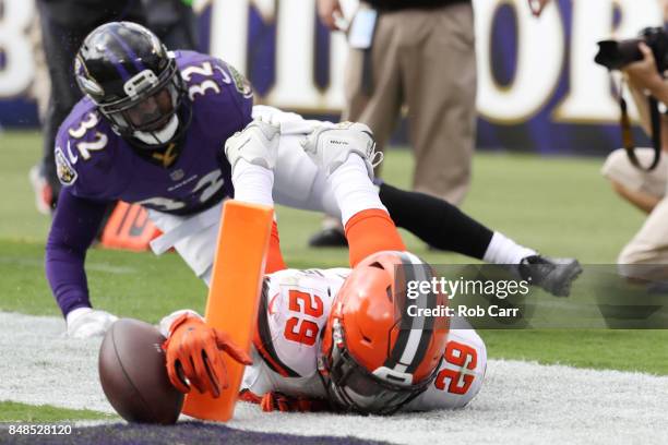 Running back Duke Johnson of the Cleveland Browns runs towards the end zone as free safety Eric Weddle of the Baltimore Ravens tackles him in the...