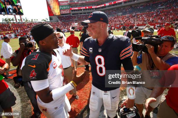 Quarterback Jameis Winston of the Tampa Bay Buccaneers and quarterback Mike Glennon of the Chicago Bears meet up on the field following the an NFL...