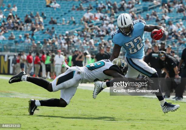 Derrick Henry of the Tennessee Titans runs with the football against Tashaun Gipson of the Jacksonville Jaguars during the second half of their game...