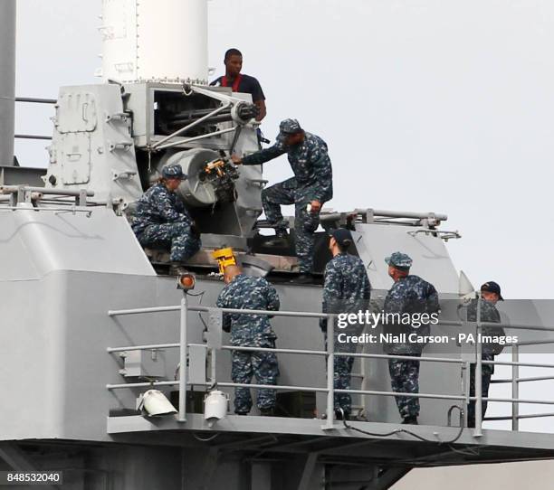 Navy personnel maintaining a Phalanx anti missile defence gun on the US Navy Ship USS Fort McHenry in Dublin port today.