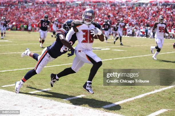 Chicago Bears wide receiver Kendall Wright is unable to catch Tampa Bay Buccaneers defensive back Robert McClain as McClain returns an interception...