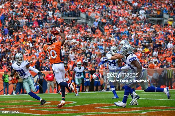 Wide receiver Emmanuel Sanders of the Denver Broncos makes a catch for a 10-yard touchdown against the Dallas Cowboys in the first quarter of a game...