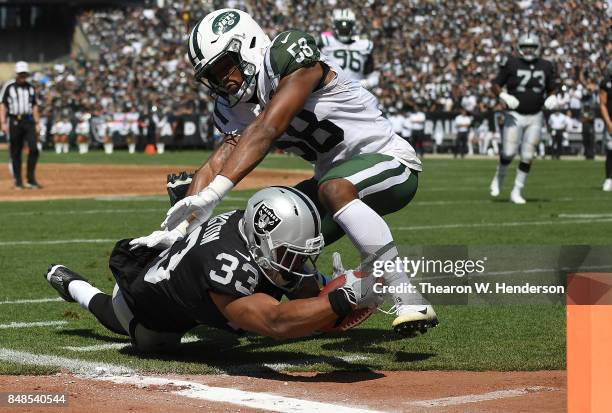 DeAndre Washington of the Oakland Raiders gets tackled at the one yard line by Darron Lee of the New York Jets during the first quarter of their NFL...