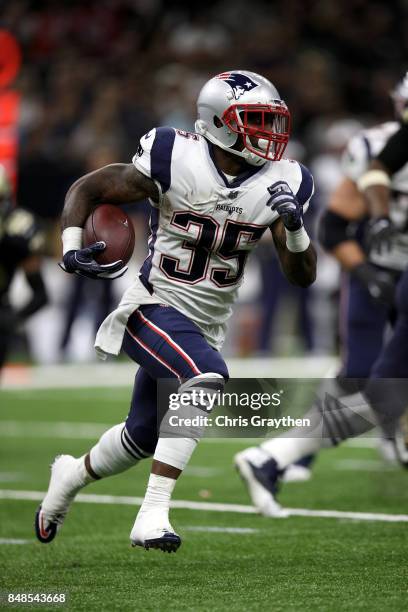 Mike Gillislee of the New England Patriots avoids a tackle by Trey Hendrickson of the New Orleans Saints at the Mercedes-Benz Superdome on September...