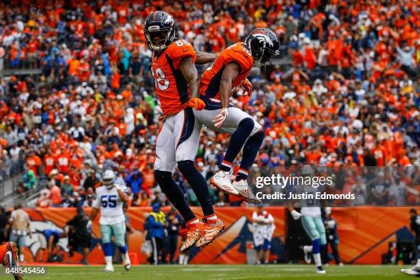 Emmanuel Sanders and wide receiver Demaryius Thomas of the Denver Broncos celebrate after a first quarter touchdown against the Dallas Cowboys at...