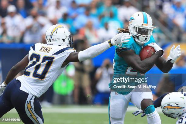 Jay Ajayi of the Miami Dolphins runs the ball against Desmond King of the Los Angeles Chargers during the first quarter at the StubHub Center on...