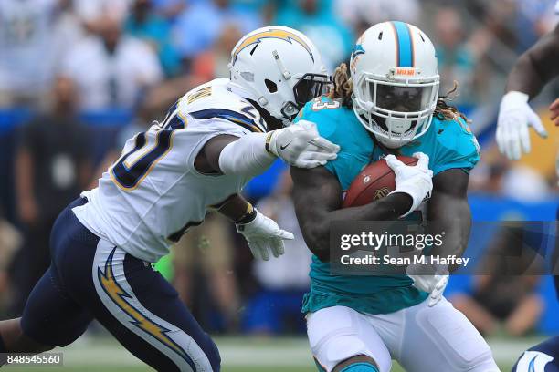 Jay Ajayi of the Miami Dolphins tries get around Desmond King of the Los Angeles Chargers during the first quarter at the StubHub Center on September...