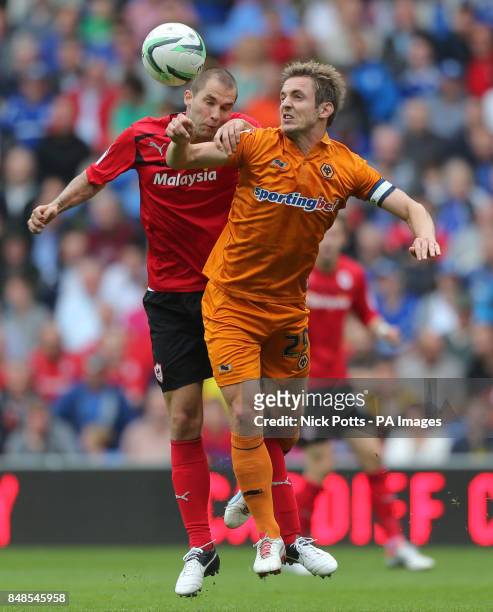Cardiff City's Matthew Connolly jumps with Wolverhampton Wanderers Kevin Doyle during the npower Football League Championship match at the Cardiff...