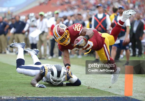 Chris Thompson of the Washington Redskins leaps for the pylon to score a touchdown over Maurice Alexander of the Los Angeles Rams during the second...