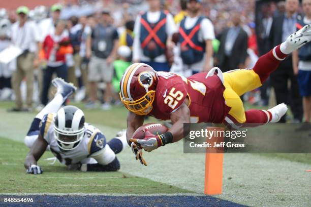 Chris Thompson of the Washington Redskins leaps for the pylon to score a touchdown over Maurice Alexander of the Los Angeles Rams during the second...