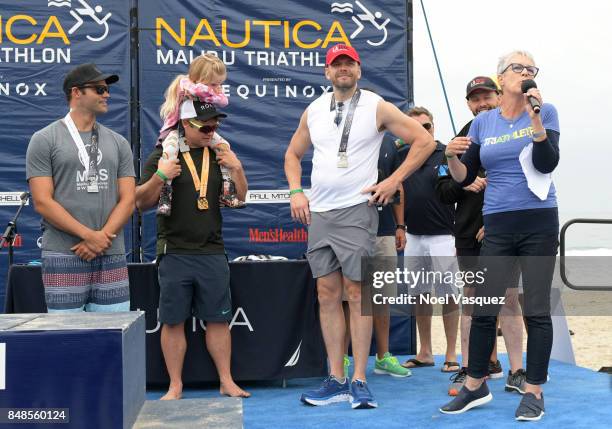 Actors Joel McHale and Jamie Lee Curtis participate in the Nautica Malibu Triathlon at Zuma Beach on September 17, 2017 in Malibu, California.