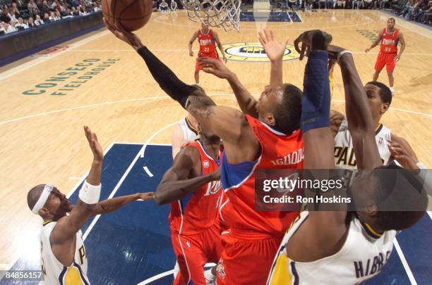 Andre Iguodala of the Philadelphia 76ers battles Roy Hibbert, Danny Granger and T. J. Ford of the Indiana Pacers at Conseco Fieldhouse on February...