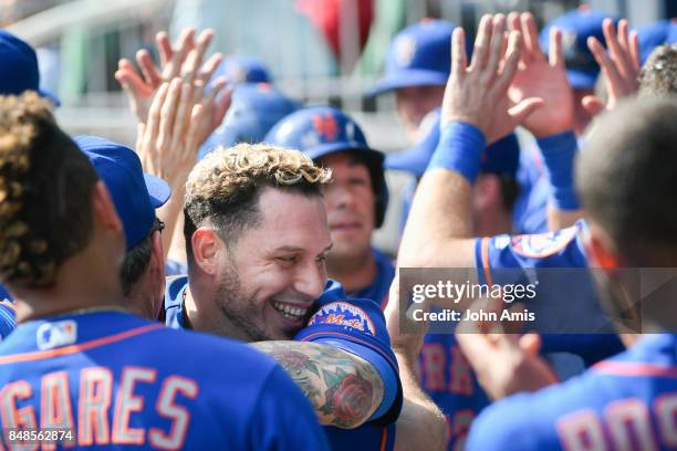 Asdrubal Cabrera of the New York Mets celebrates in the dugout after hitting a two run home run against the Atlanta Braves in the ninth inning at...