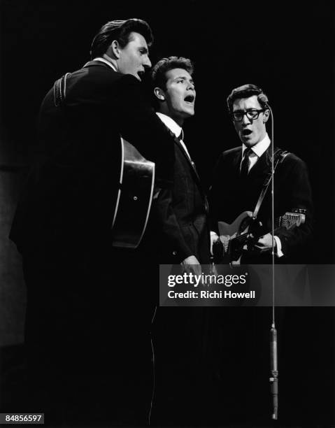 Photo of SHADOWS and Hank MARVIN and Bruce WELCH and Cliff RICHARD, with The Shadows - L-R: Bruce Welch, Cliff Richard, Hank Marvin - performing live...