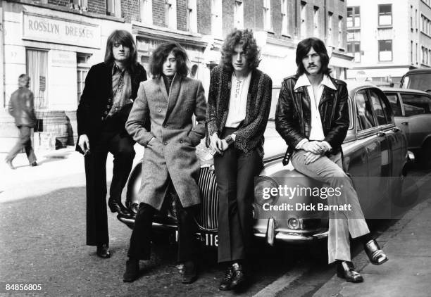 English rock group Led Zeppelin posed sitting on car bonnet during their first photo shoot for WEA records in London in December 1968. L-R John Paul...