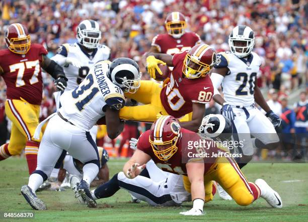 Jamison Crowder of the Washington Redskins goes airborne as Maurice Alexander of the Los Angeles Rams defends during the first quarter at Los Angeles...