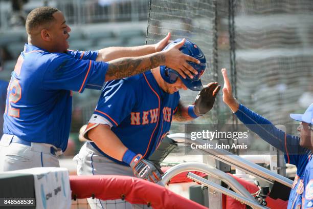 Asdrubal Cabrera of the New York Mets celebrates with Dominic Smith, left, as he enters the dugout after hitting a two run home run against the...