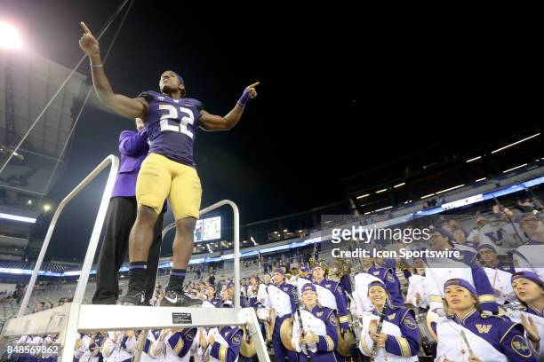 Washington's Lavon Coleman leads the band in the playing of the school fight song after the game against the Fresno State Bulldogs on September 16,...