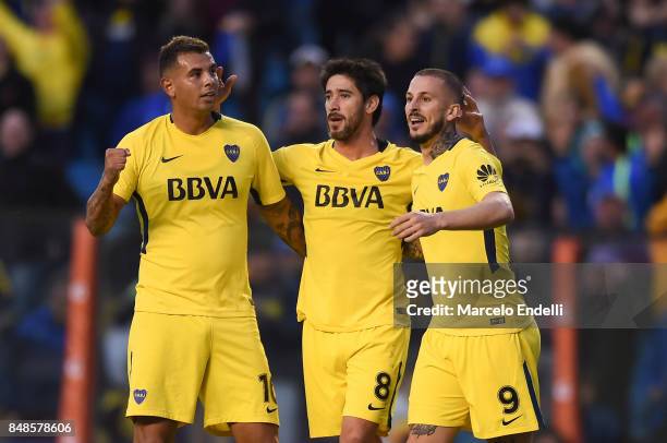 Pablo Perez of Boca Juniors celebrates with teammates Edwin Cardona and Dario Benedetto after scoring the second goal of his team during a match...