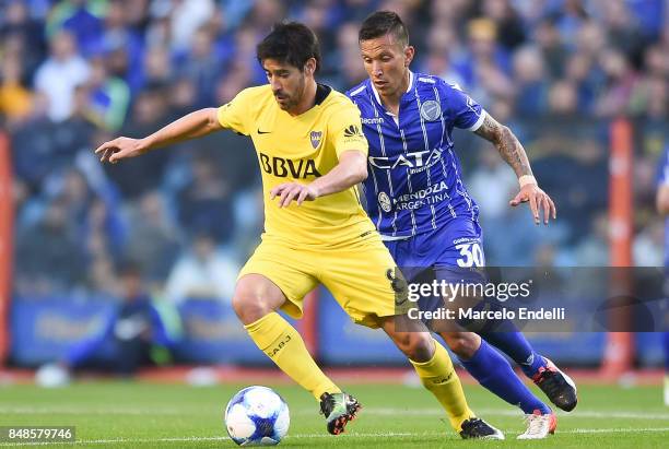 Pablo Perez of Boca Juniors fights for the ball with Juan Andrada of Godoy Cruz during a match between Boca Juniors and Godoy Cruz as part of...