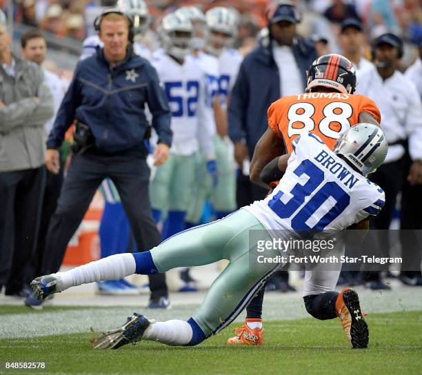 Dallas Cowboys cornerback Anthony Brown tries to bring down Denver Broncos wide receiver Demaryius Thomas during the first quarter on Sunday, Sept....