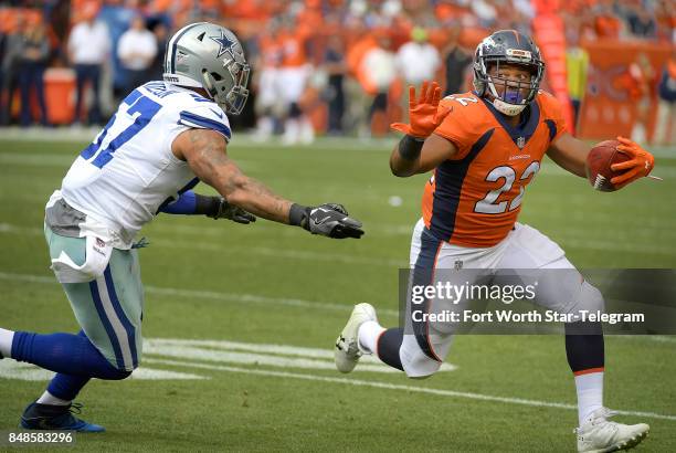 Dallas Cowboys outside linebacker Damien Wilson can't bring down Denver Broncos running back C.J. Anderson during the first quarter on Sunday, Sept....