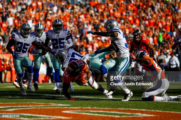 Running back C.J. Anderson of the Denver Broncos rushes after a catch for a second quarter touchdown against the Dallas Cowboys at Sports Authority...