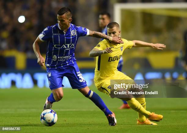 Juan Andrada of Godoy Cruz fights for the ball with Dario Benedetto of Boca Juniors during a match between Boca Juniors and Godoy Cruz as part of...