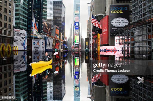 businessman in kayak in flooded times square - flood city stock pictures, royalty-free photos & images