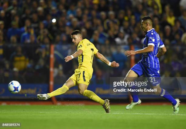 Cristian Pavon of Boca Juniors kicks the ball to score the third goal of his team during a match between Boca Juniors and Godoy Cruz as part of...