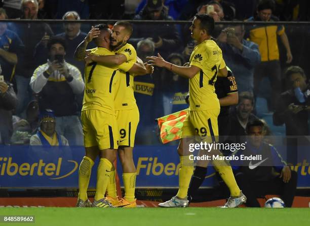 Cristian Pavon of Boca Juniors celebrates with teammates Dario Benedetto and Leonardo Jara after scoring the third goal of his team during a match...