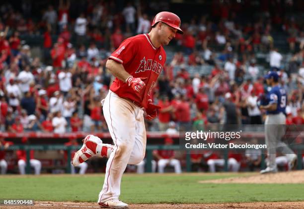 Mike Trout of the Los Angeles Angels of Anaheim jogs to first base on a solo homerun against pitcher Matt Bush of the Texas Rangers during the eighth...