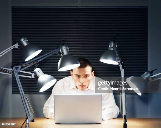 desperate man working on his laptop. - interrogatorio foto e immagini stock
