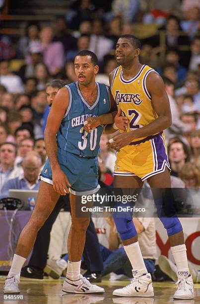 Dell Curry of the Charlotte Hornets guards Magic Johnson of the Los Angeles Lakers during an NBA game at Charlotte Colesium in 1989.