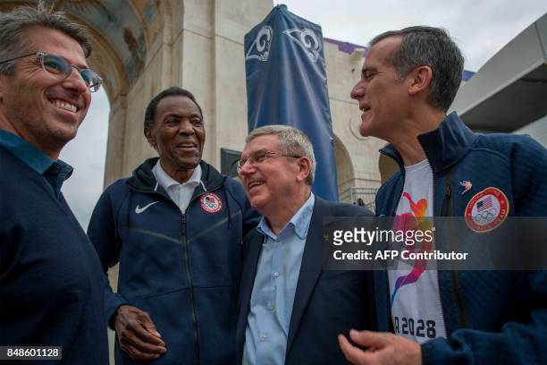Chairman Casey Wasserman , Olympic gold medalist Rafer Johnson , International Olympic Committee President Thomas Bach and Los Angeles Mayor Eric...