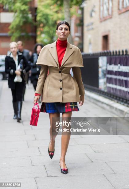 Giovanna Engelbert wearing red turtleneck, beige jacket outside Anya Hindmarch during London Fashion Week September 2017 on September 17, 2017 in...
