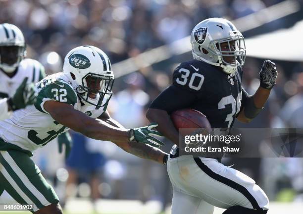 Jalen Richard of the Oakland Raiders breaks free from Juston Burris of the New York Jets on his way to scoring a touchdown at Oakland-Alameda County...