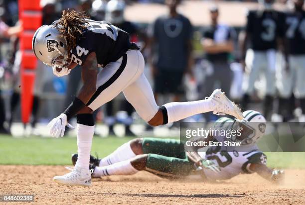 Cordarrelle Patterson of the Oakland Raiders breaks free from Juston Burris of the New York Jets to score a touchdown at Oakland-Alameda County...