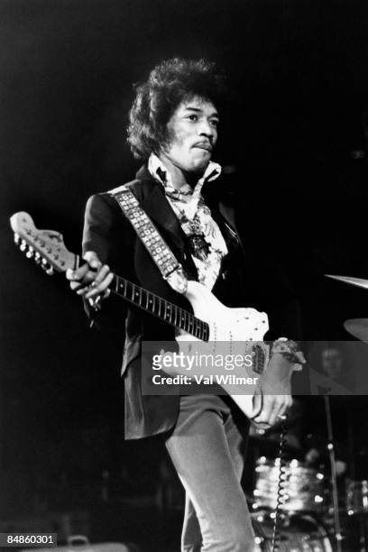 Photo of Jimi HENDRIX; performing live onstage, playing white Fender Stratocaster guitar