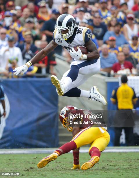 Todd Gurley of the Los Angeles Rams leaps over Kendall Fuller of the Washington Redskins at Los Angeles Memorial Coliseum on September 17, 2017 in...