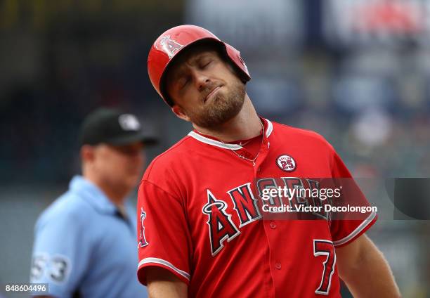 Cliff Pennington of the Los Angeles Angels of Anaheim reacts after hitting into a double play as umpire Greg Gibson looks on during the ninth inning...