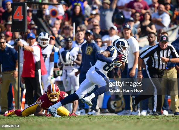 Gerald Everett of the Los Angeles Rams makes a catch over Fabian Moreau of the Washington Redskins on a fake punt during the fourth quarter at Los...