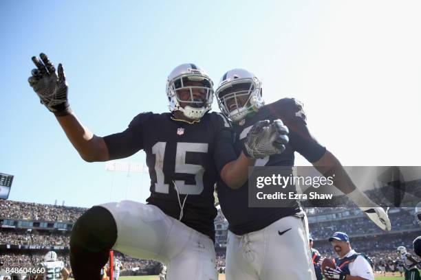 Michael Crabtree of the Oakland Raiders celebrates with Marshall Newhouse and he Crabtree scored a touchdown against the New York Jets at...