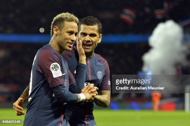 Neymar Jr and Dani Alves of Paris Saint-Germain react after Kylian Mbappe scored during the Ligue 1 match between Paris Saint Germain and Olympique...