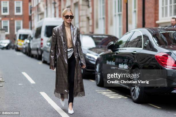 Caroline Daur wearing a checked Calvin Klein coat, belt bag outside Preen during London Fashion Week September 2017 on September 17, 2017 in London,...