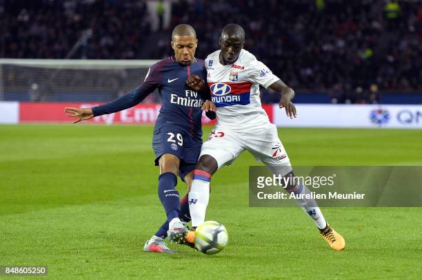 Kyian Mbappe of Paris Saint-Germain and Tanguy Ndombele of Olympique Lyonnais fight for the ball during the Ligue 1 match between Paris Saint Germain...