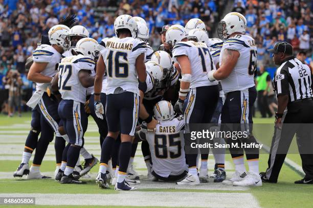 Philip Rivers Tyrell Williams and Branden Oliver congratulate Antonio Gates of the Los Angeles Chargers after he scored a passing touchdown during...